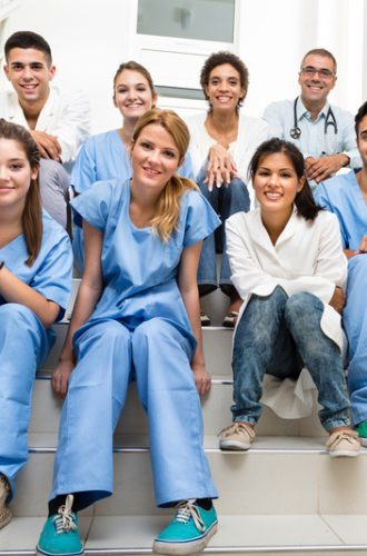 Medical students and team Group of medical students and teacher sitting on the stairs.